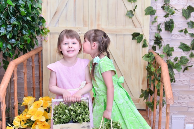 Beautiful cute  girls  posing  with flowers 