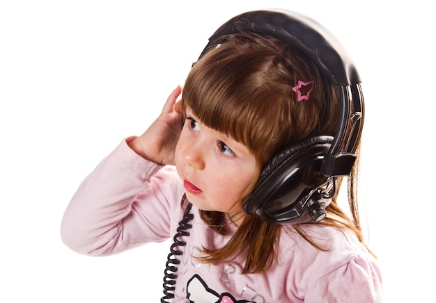 Beautiful cute happy little girl with headphones