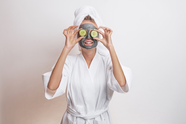 Beautiful cute model posing in a white waffle bathrobe and a towel on her head