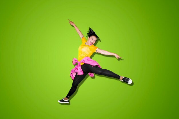 Beautiful dancer jumping high in the studio