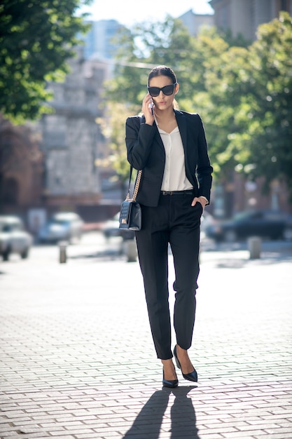 Beautiful dark-haired woman talking on the phone