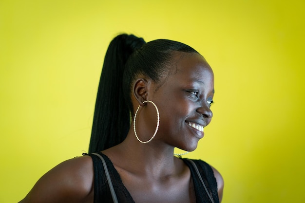 Beautiful dark skin young woman portrait on yellow