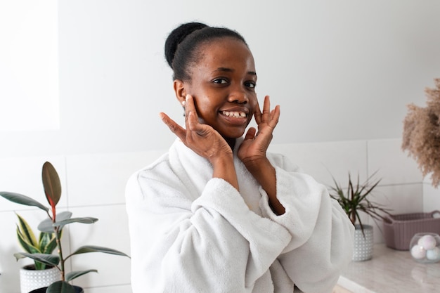 Beautiful dark skinned girl admiring herself touching cheeks