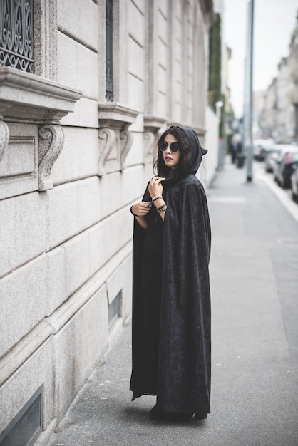 beautiful dark vampire woman with black mantle and hood