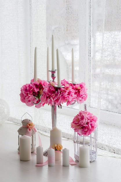 Beautiful decor of candles and flowers. White Pink shades.