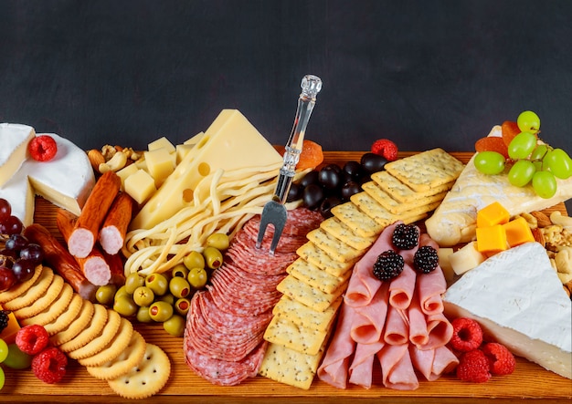 A beautiful decor of fresh cheese and meat crackers, green olives