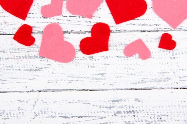 Beautiful decorative hearts on old wooden background