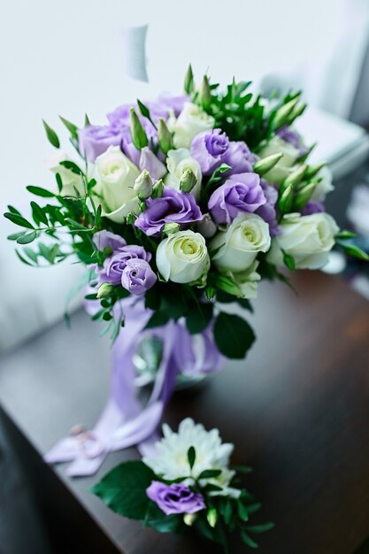 Beautiful delicate bridal bouquet white and purple on the table