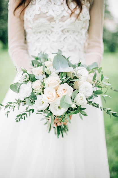 Beautiful and delicate wedding bouquet in bride hands