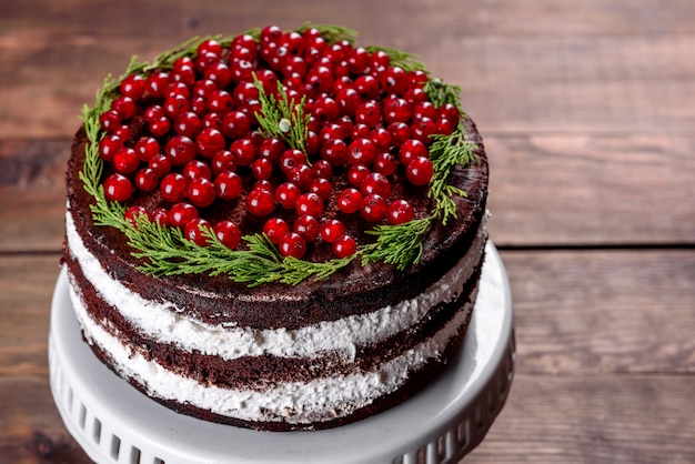 Beautiful delicious cake with bright red berries on the Christmas table