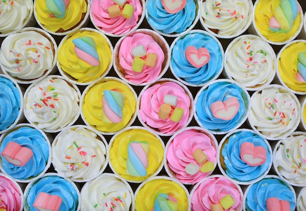 Beautiful delicious Cupcakes background. Top view.