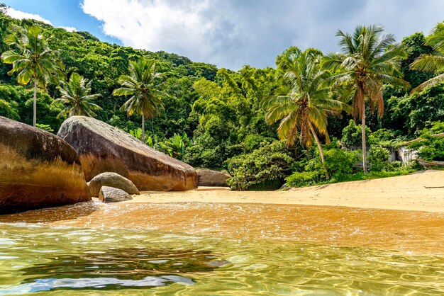 Beautiful deserted and unspoilt beach surrounded by rainforest on Ilha Grande south coast of Rio de Janeiro