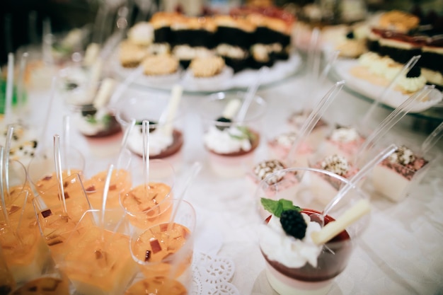 Beautiful dessert table with sweet snacks in the restaurant at the wedding party