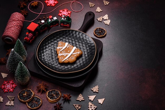 Beautiful different Christmas decorations and gingerbread on a brown concrete table