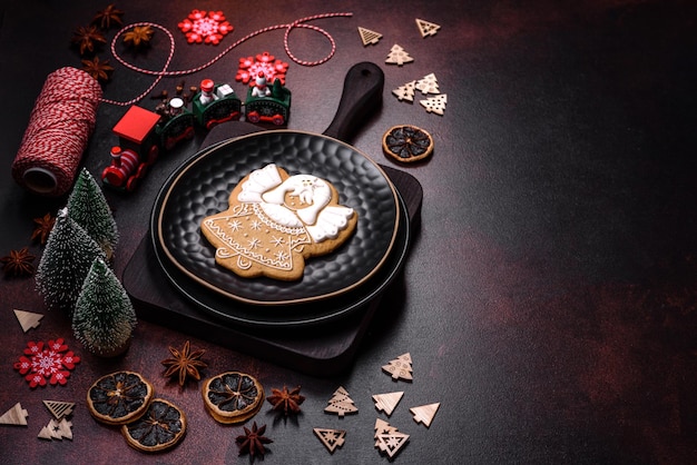 Beautiful different Christmas decorations and gingerbread on a brown concrete table