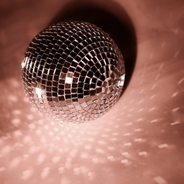 Beautiful disco ball on yellow background isolated.