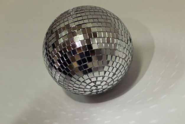 Beautiful disco ball on yellow background isolated