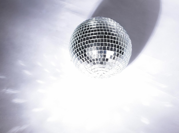 Beautiful disco ball on yellow background isolated