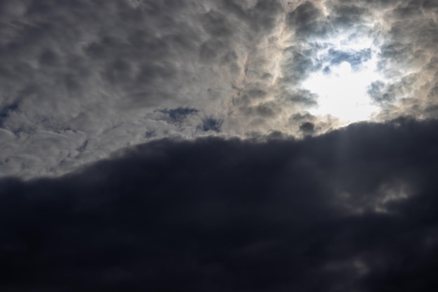 Beautiful dramatic apocalyptic sky cloud storm pattern background Sun rays through the clouds