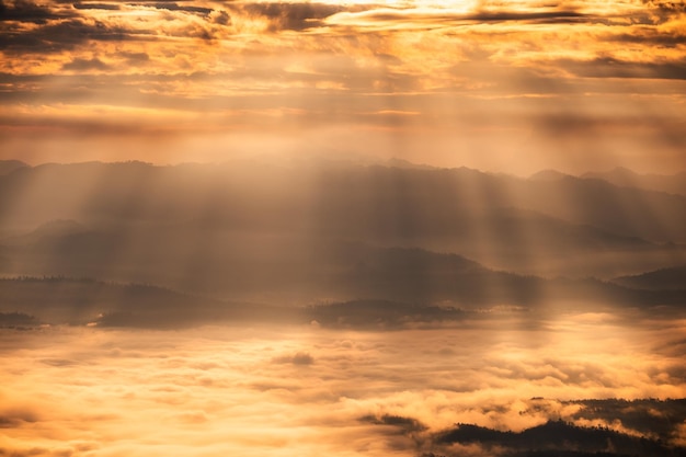 Beautiful dramatic sunrise shining on mountain with foggy in the valley at national park