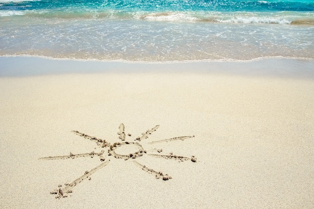 Beautiful drawing on the sand near the sea shore