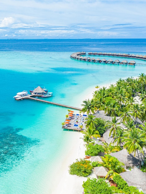 Beautiful drone aerial resort Maldives islands. Exotic travel destination, ocean lagoon palm trees