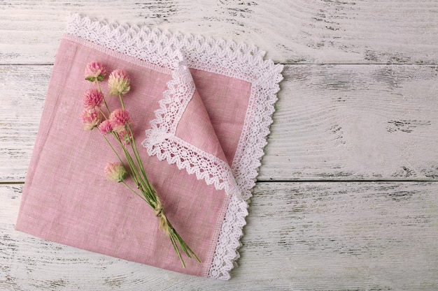 Beautiful dry flowers on napkin on wooden background