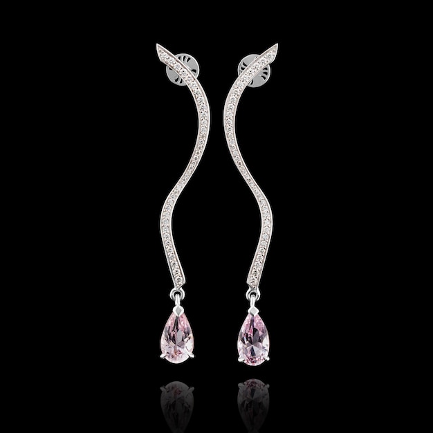 Beautiful earrings with diamonds and morganite on a black background