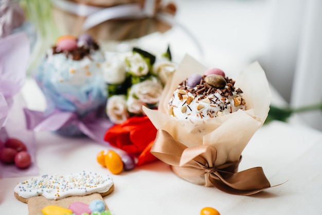 Beautiful Easter cakes with Easter eggs on a decorated light table. Bright Easter holiday.