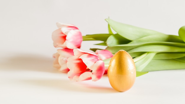 beautiful Easter card, background with flowers and Golden egg