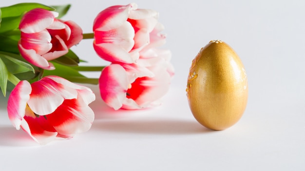 beautiful Easter card, background with flowers and Golden egg