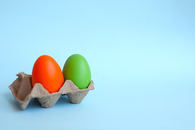 beautiful Easter composition on a blue background, colorful eggs, top view.