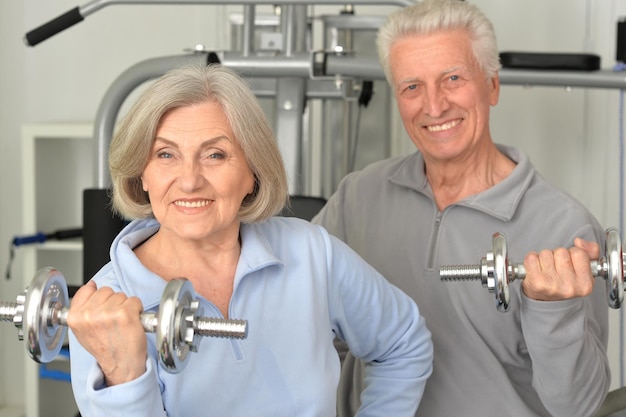 Beautiful elderly couple in a gym