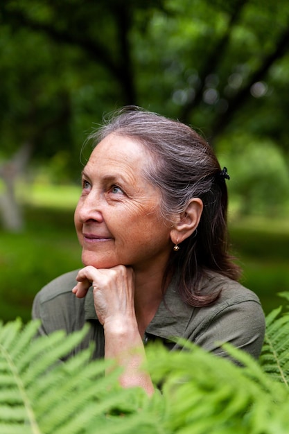 Beautiful elderly woman poses on a summer day