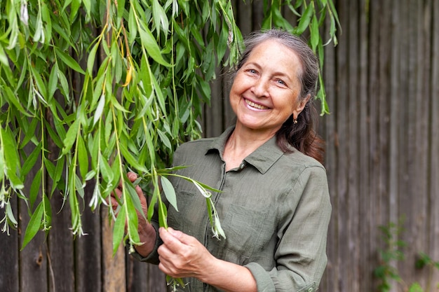 Beautiful elderly woman poses on a summer day