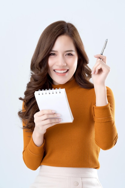 Beautiful elegance asian woman brown sweater dress hand hold paper note and pencil thinking ideas concept white background