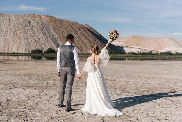 Beautiful elegant couple of newlyweds in love on a beautiful natural background of salt mountains and quarries