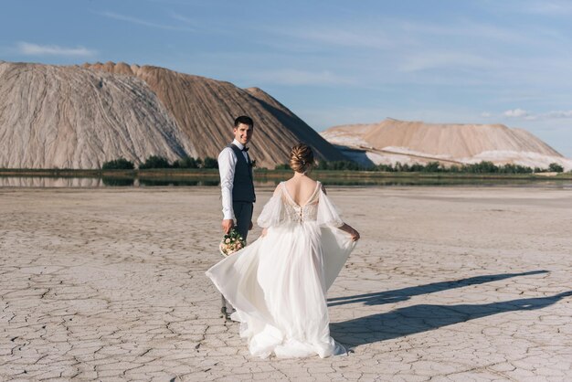 Beautiful elegant couple of newlyweds in love on a beautiful natural background of salt mountains and quarries