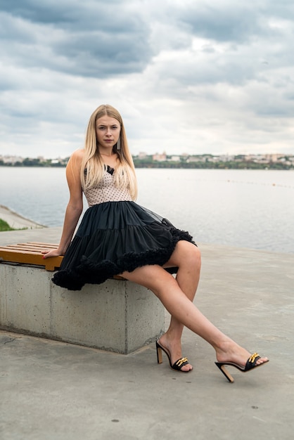 Beautiful elegant woman in a long dress at nature