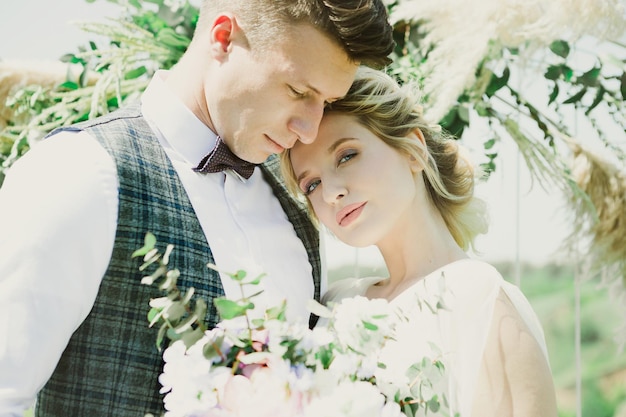 Beautiful emotional bride with the groom in nature