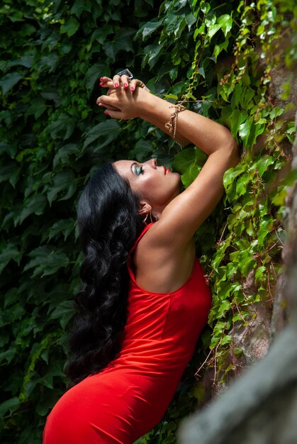 Beautiful emotional woman in red on the street.