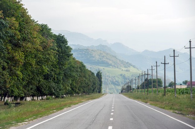 夏の山の背景に美しい空のアスファルト道路