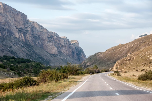 Beautiful empty asphalt road against the backdrop of mountains in summer