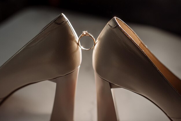 Beautiful engagement ring beetween shoes in dramatic lightning