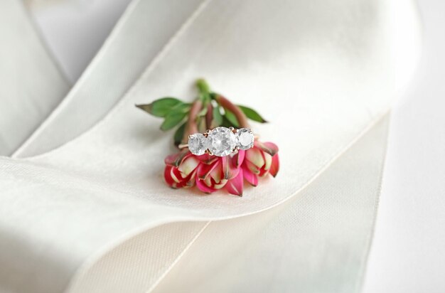 Beautiful engagement ring with flower on ribbon