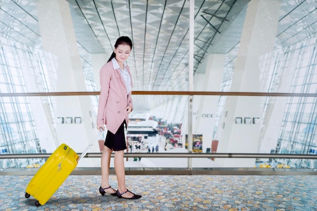 Beautiful entrepreneur walks at airport terminal