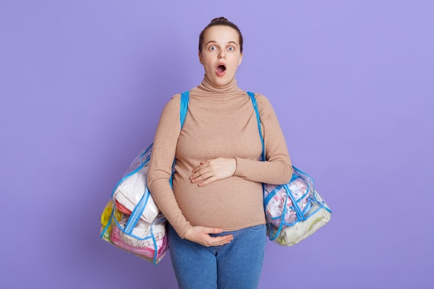 아름 다운 유럽 여자 기대 아기, 임신 배를 만지고 두려워 보인다