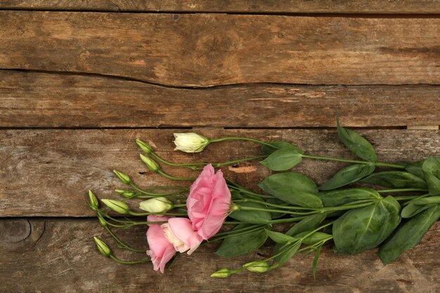 Beautiful eustoma on wooden background