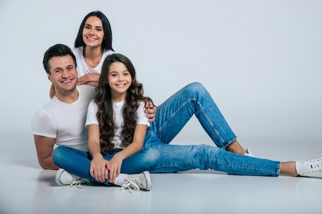 Premium Photo | Beautiful excited and the funny family team is posing in a white t-shirt while they isolated on white background in studio. Premium Photo | Beautiful excited and the funny family team is posing in a white t-shirt while they isolated on white background in studio.