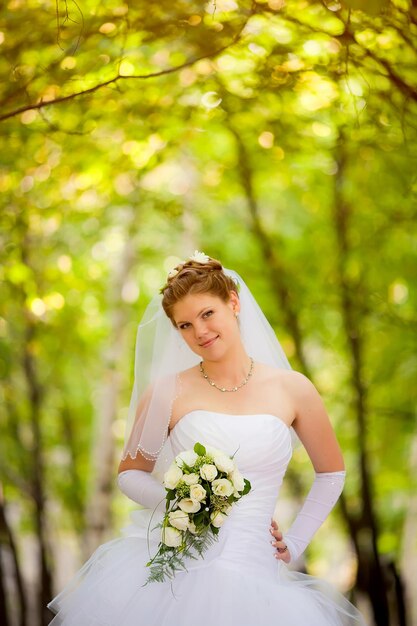 Beautiful fabulous happy brunette bride with stylish bouquet